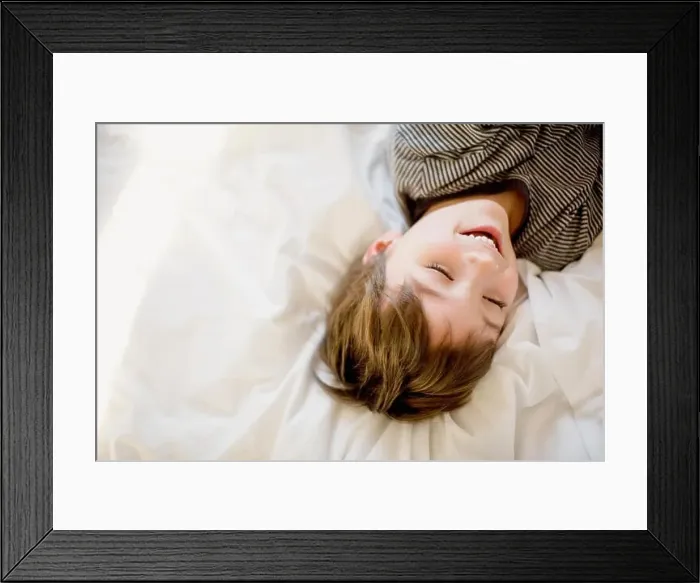 Framed Print : Happy boy lying on the bed Framed Print : Happy boy lying on the bed