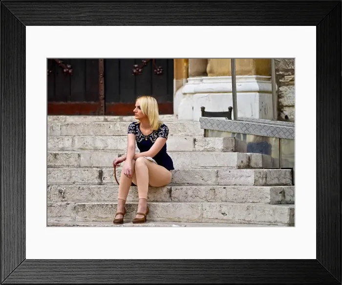 Framed Print : A blonde woman waiting in the stairs of a church Framed Print : A blonde woman waiting in the stairs of a church