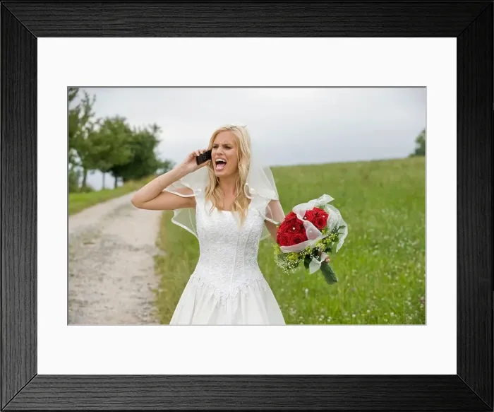 Framed Print : Bride shouting on the phone, holding bouquet Framed Print : Bride shouting on the phone, holding bouquet