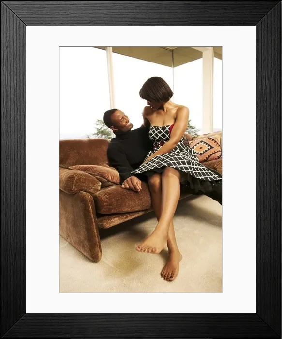 Framed Print : A couple cuddling on the sofa
