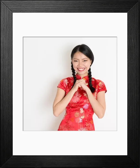 Framed Print : Happy Chinese New Year!! Portrait of Asian Chinese girl greeting, in traditional red qipao standing on plain background Framed Print : Happy Chinese New Year!! Portrait of Asian Chinese girl greeting, in traditional red qipao standing on plain background
