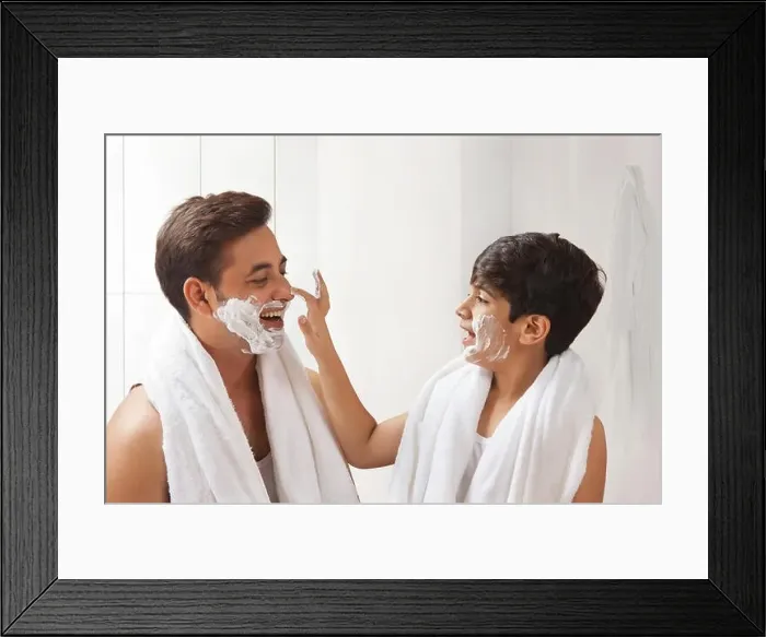 Framed Print : Father and son putting shaving cream on face Framed Print : Father and son putting shaving cream on face