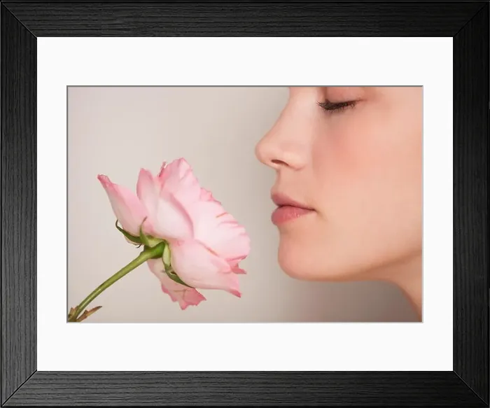 Framed Print : Beautiful woman smelling a flower Framed Print : Beautiful woman smelling a flower