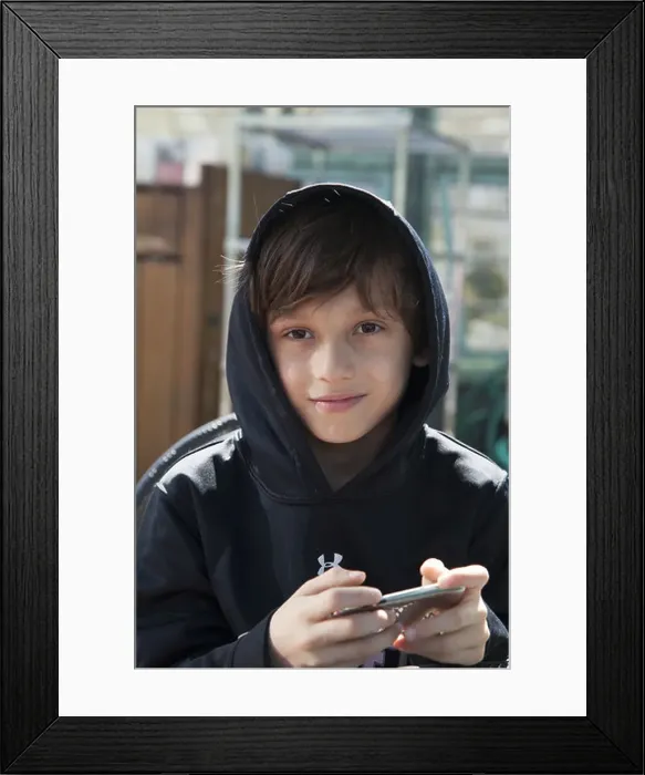 Framed Print : 9 year old boy plays Minecraft on his ipod Framed Print : 9 year old boy plays Minecraft on his ipod