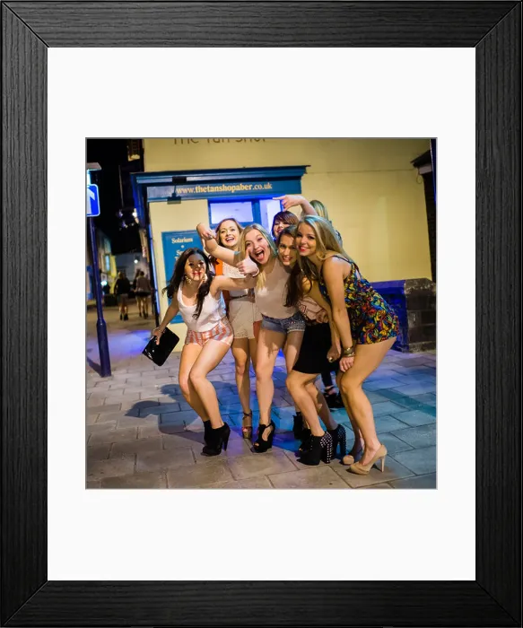 Framed Print : A Group of young girls women wearing shorts out on the streets celebrating and partying on Saturday night Framed Print : A Group of young girls women wearing shorts out on the streets celebrating and partying on Saturday night