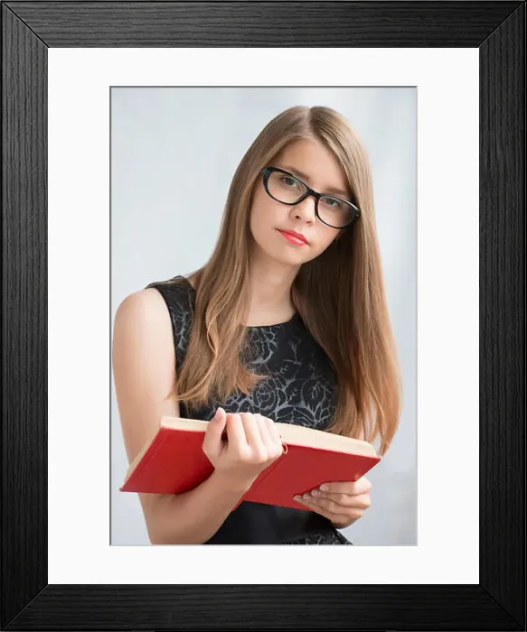 Framed Print : Teenage girl in glasses with books Framed Print : Teenage girl in glasses with books