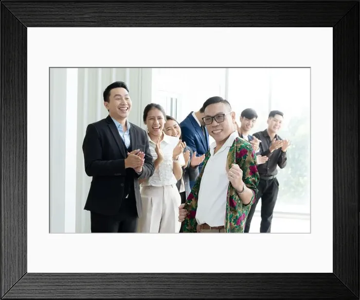 Framed Print : A group of people are smiling and clapping, with one man in a floral shirt standing out. Scene is happy and celebratory Framed Print : A group of people are smiling and clapping, with one man in a floral shirt standing out. Scene is happy and celebratory