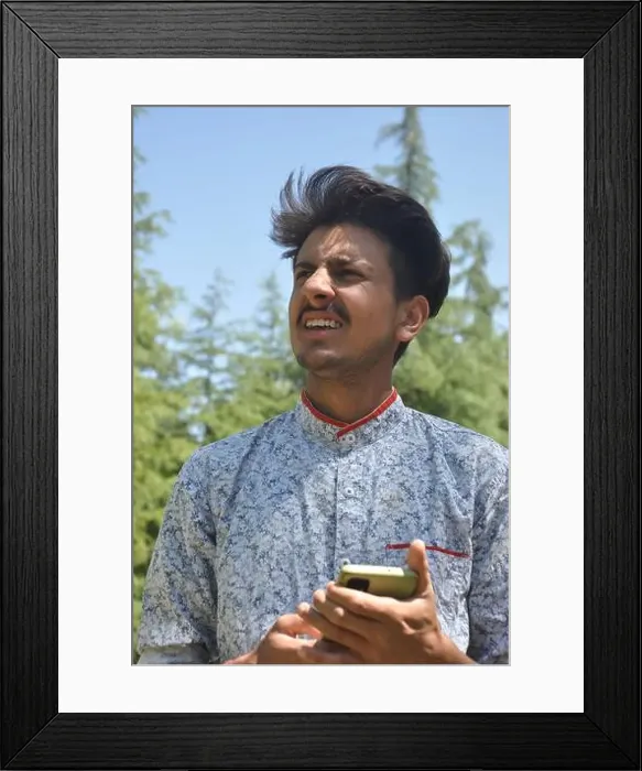 Framed Print : Closeup portrait of a Indian good looking young guy standing outdoor in nature Framed Print : Closeup portrait of a Indian good looking young guy standing outdoor in nature