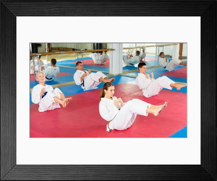 Framed Print : Men and women in kimono doing crunches in gym Framed Print : Men and women in kimono doing crunches in gym