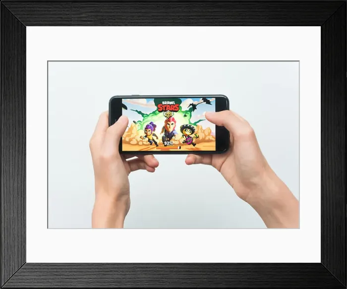 Framed Print : Samara, Russia -07, 29, 2019: A young guy playing brawl stars game on Iphone 8 Plus Framed Print : Samara, Russia -07, 29, 2019: A young guy playing brawl stars game on Iphone 8 Plus