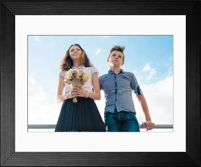 Framed Print : Happy couple of teens boy and girl 14, 15 years old. Young people smiling and talking, blue sky background Framed Print : Happy couple of teens boy and girl 14, 15 years old. Young people smiling and talking, blue sky background