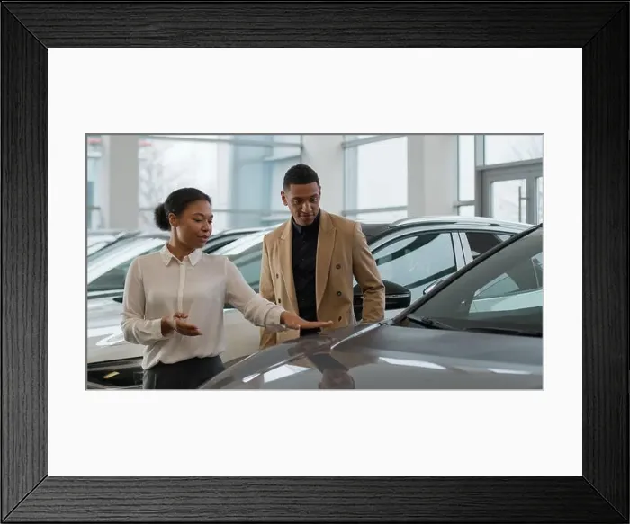 Framed Print : African American woman manager trader dealer seller female saleswoman help consult male client customer in auto salon