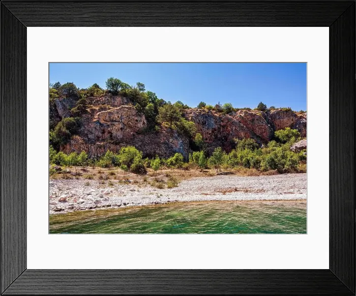 Framed Print : The rocky shoreline of Megali Prespa Lake in Greece