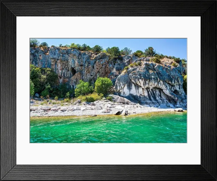 Framed Print : The rocky shoreline of Megali Prespa Lake in Greece