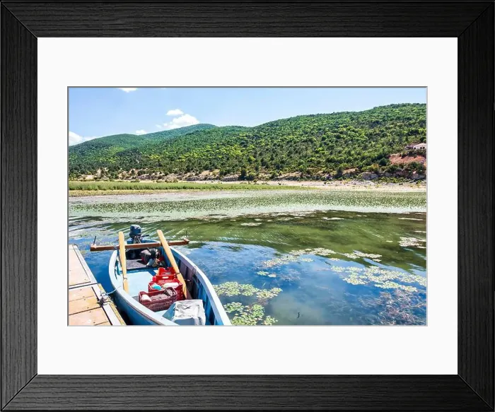Framed Print : A small fishing boat docked on the calm waters of Lake Prespa near Psarades village Framed Print : A small fishing boat docked on the calm waters of Lake Prespa near Psarades village