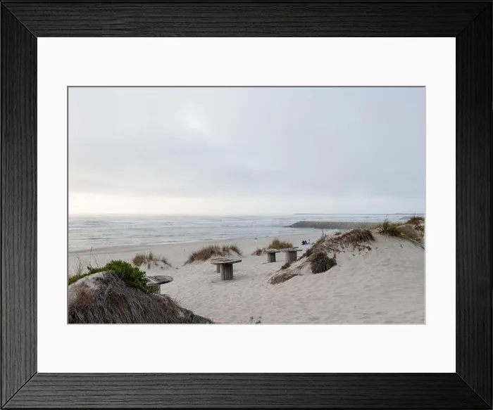 Framed Print : A serene beach with dunes and views of a calm ocean under a cloudy late-day sky Framed Print : A serene beach with dunes and views of a calm ocean under a cloudy late-day sky
