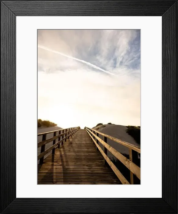 Framed Print : A wooden boardwalk between the sand dunes towards the sea at a beautiful sunset Framed Print : A wooden boardwalk between the sand dunes towards the sea at a beautiful sunset