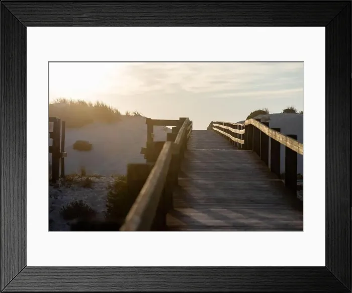 Framed Print : A wooden boardwalk between the sand dunes towards the sea at a beautiful sunset Framed Print : A wooden boardwalk between the sand dunes towards the sea at a beautiful sunset