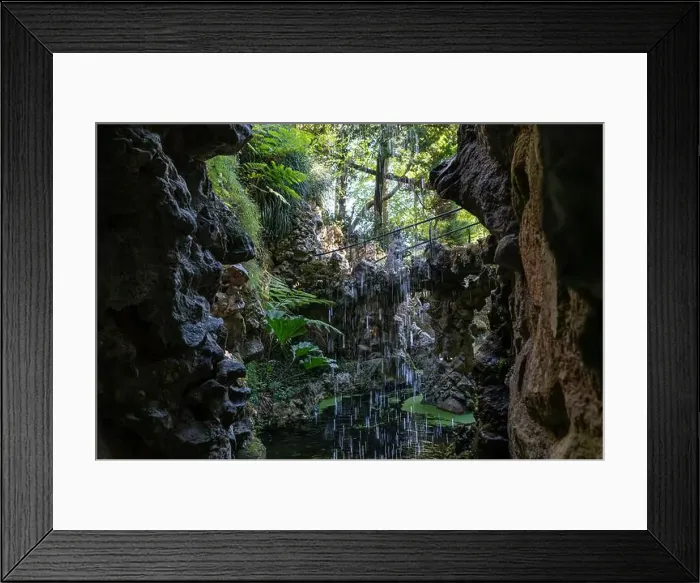 Framed Print : Water trickles down rocky cliffs into a peaceful pond, surrounded by vibrant foliage Framed Print : Water trickles down rocky cliffs into a peaceful pond, surrounded by vibrant foliage