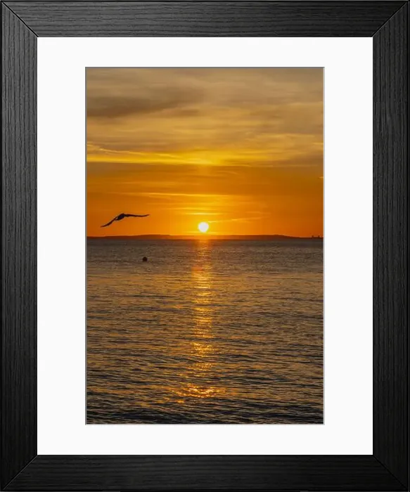 Framed Print : The sun setting over the Welsh coast with a streak of Sunlight going across the sea Framed Print : The sun setting over the Welsh coast with a streak of Sunlight going across the sea