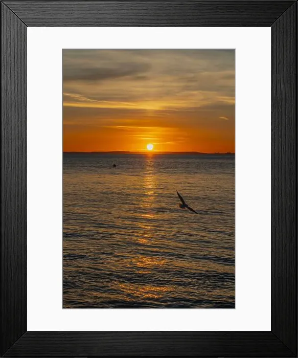 Framed Print : The sun setting over the Welsh coast with a streak of Sunlight going across the sea Framed Print : The sun setting over the Welsh coast with a streak of Sunlight going across the sea