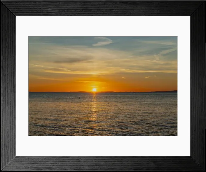 Framed Print : The sun setting over the Welsh coast with a streak of Sunlight going across the sea Framed Print : The sun setting over the Welsh coast with a streak of Sunlight going across the sea