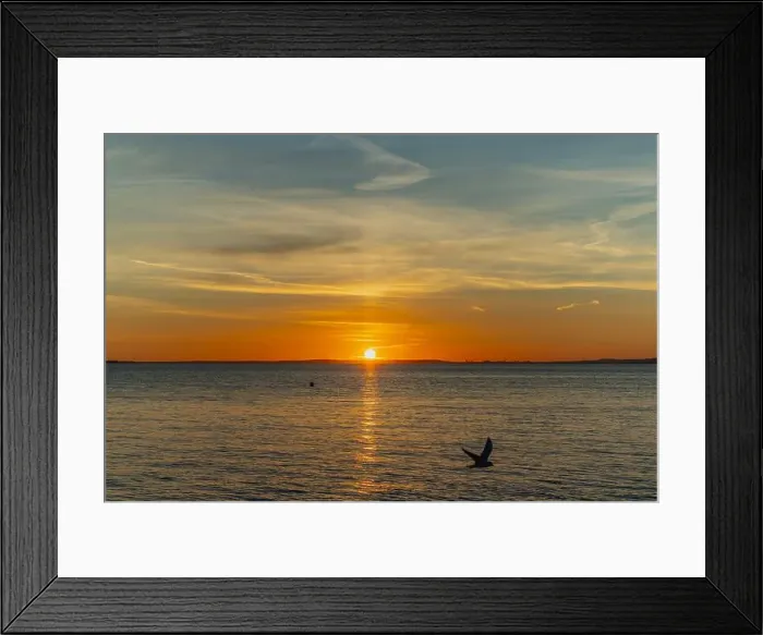 Framed Print : The sun about to set over the Welsh coast with a reddish orangey glow along the horizon Framed Print : The sun about to set over the Welsh coast with a reddish orangey glow along the horizon