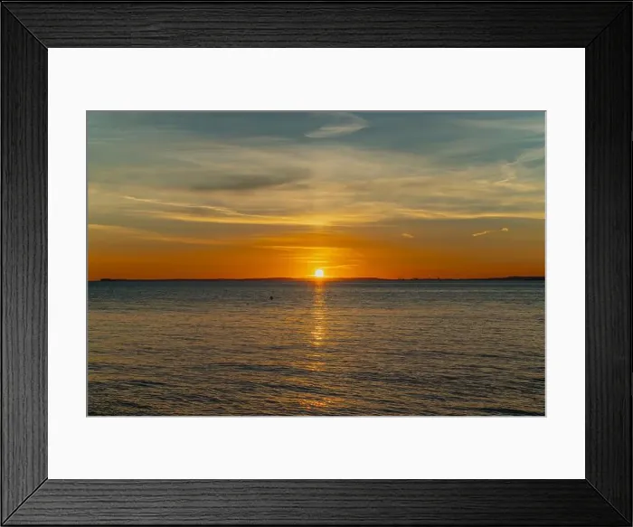 Framed Print : The sun setting over the Welsh coast with a streak of Sunlight going across the sea Framed Print : The sun setting over the Welsh coast with a streak of Sunlight going across the sea