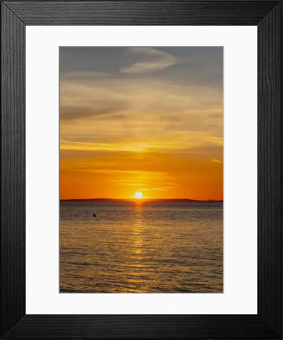 Framed Print : The sun about to set over the Welsh coast with a reddish orangey glow along the horizon Framed Print : The sun about to set over the Welsh coast with a reddish orangey glow along the horizon