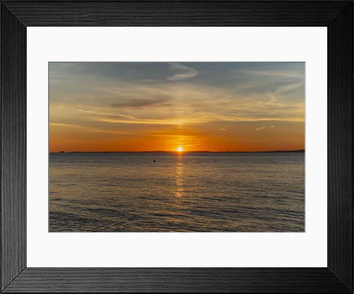 Framed Print : The sun about to set over the Welsh coast with a reddish orangey glow along the horizon Framed Print : The sun about to set over the Welsh coast with a reddish orangey glow along the horizon