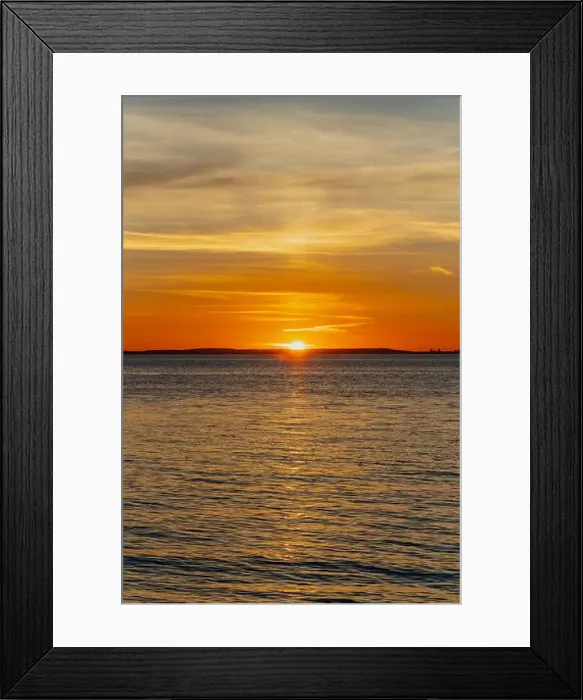 Framed Print : The sun about to set over the Welsh coast with a reddish orangey glow along the horizon Framed Print : The sun about to set over the Welsh coast with a reddish orangey glow along the horizon