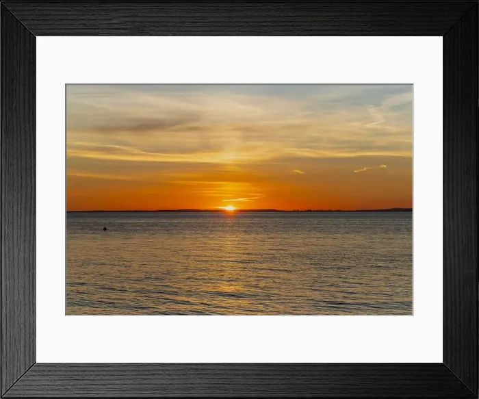 Framed Print : The sun about to set over the Welsh coast with a reddish orangey glow along the horizon Framed Print : The sun about to set over the Welsh coast with a reddish orangey glow along the horizon