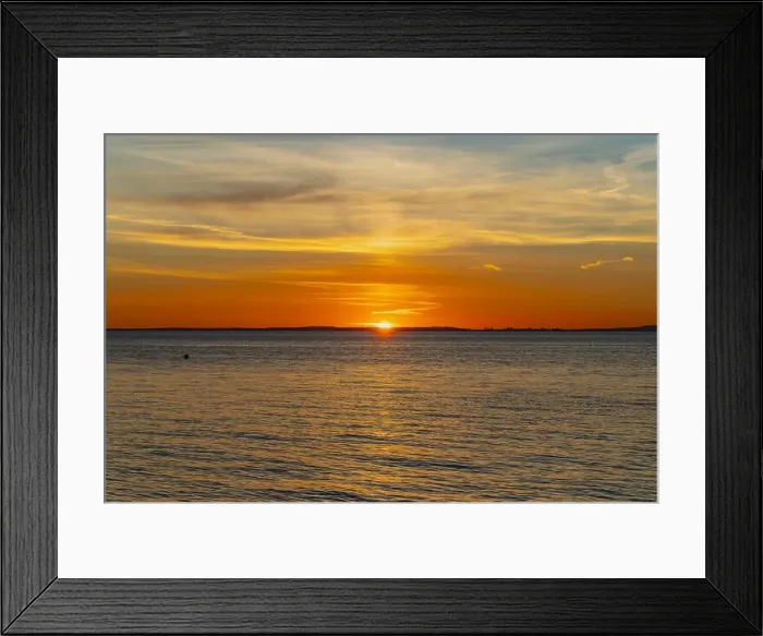 Framed Print : The sun about to set over the Welsh coast with a reddish orangey glow along the horizon Framed Print : The sun about to set over the Welsh coast with a reddish orangey glow along the horizon
