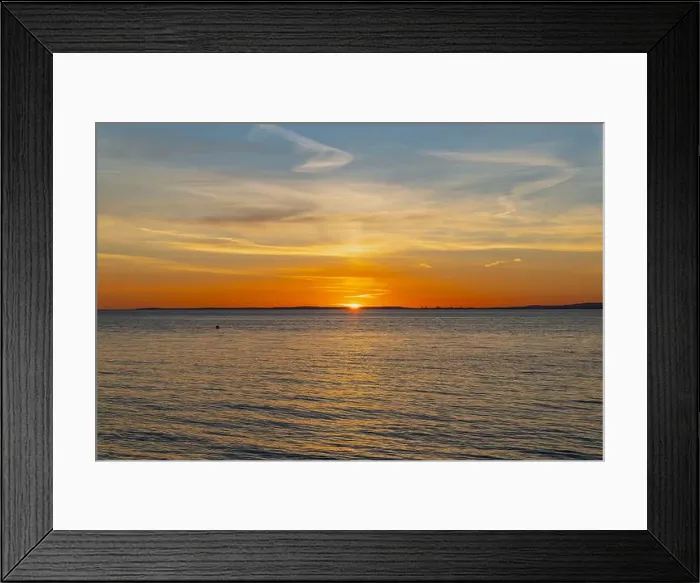Framed Print : The sun about to set over the Welsh coast with a reddish orangey glow along the horizon Framed Print : The sun about to set over the Welsh coast with a reddish orangey glow along the horizon