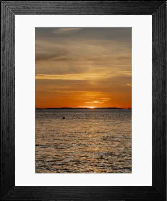 Framed Print : The sun about to set over the Welsh coast with a reddish orangey glow along the horizon Framed Print : The sun about to set over the Welsh coast with a reddish orangey glow along the horizon
