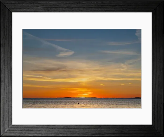 Framed Print : The sun about to set over the Welsh coast with a reddish orangey glow along the horizon Framed Print : The sun about to set over the Welsh coast with a reddish orangey glow along the horizon