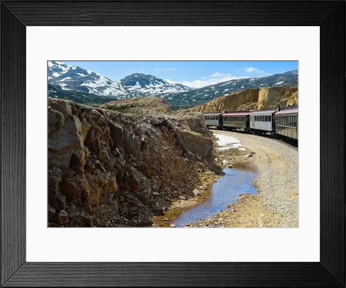 Framed Print : A train on the White Pass and Yukon Route railroad out of Skagway, Alaska, rounds the loop at the top of the pass Framed Print : A train on the White Pass and Yukon Route railroad out of Skagway, Alaska, rounds the loop at the top of the pass