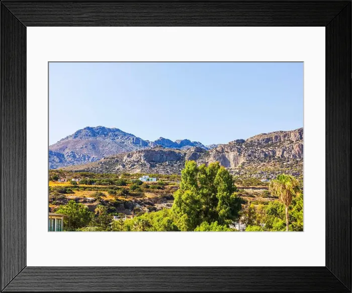 Framed Print : Mountain landscape with rocky cliffs and green trees under bright blue sky in sunny weather. Crete. Greece