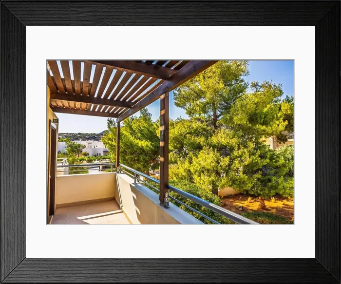 Framed Print : Balcony view with wooden pergola overlooking lush green trees and resort on sunny day on Crete island Framed Print : Balcony view with wooden pergola overlooking lush green trees and resort on sunny day on Crete island