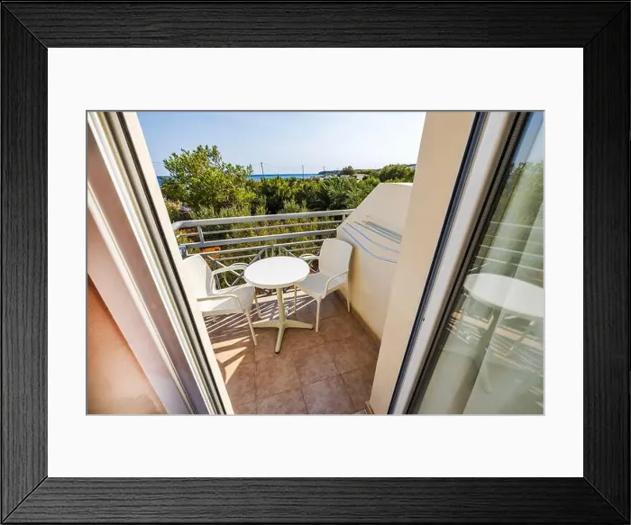 Framed Print : View from hotel room balcony with white furniture overlooking Mediterranean greenery and sea. Crete. Greece Framed Print : View from hotel room balcony with white furniture overlooking Mediterranean greenery and sea. Crete. Greece