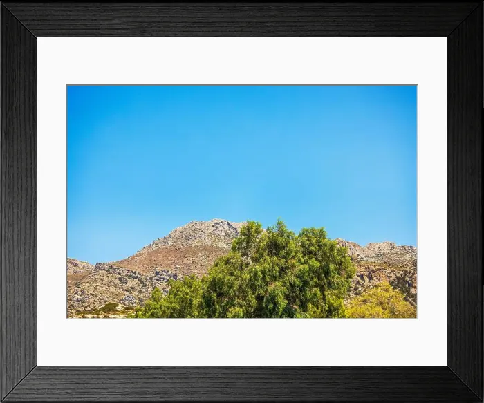 Framed Print : Rocky mountain landscape with green trees in foreground under bright clear blue sky. Crete. Greece Framed Print : Rocky mountain landscape with green trees in foreground under bright clear blue sky. Crete. Greece