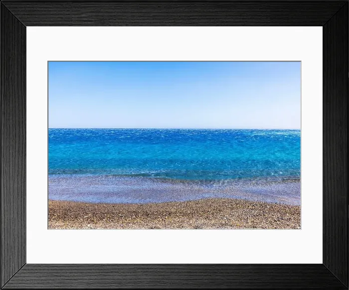 Framed Print : Clear blue Mediterranean sea with small pebbles on shore under sunny sky, with calm water stretching to horizon Framed Print : Clear blue Mediterranean sea with small pebbles on shore under sunny sky, with calm water stretching to horizon