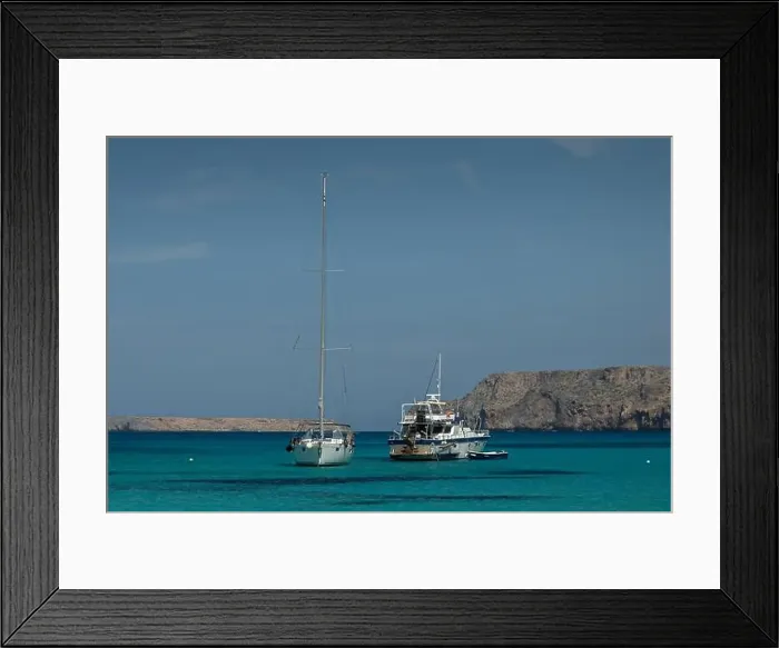 Framed Print : Two sailboats anchored in the clear blue waters of Gramvousa Framed Print : Two sailboats anchored in the clear blue waters of Gramvousa