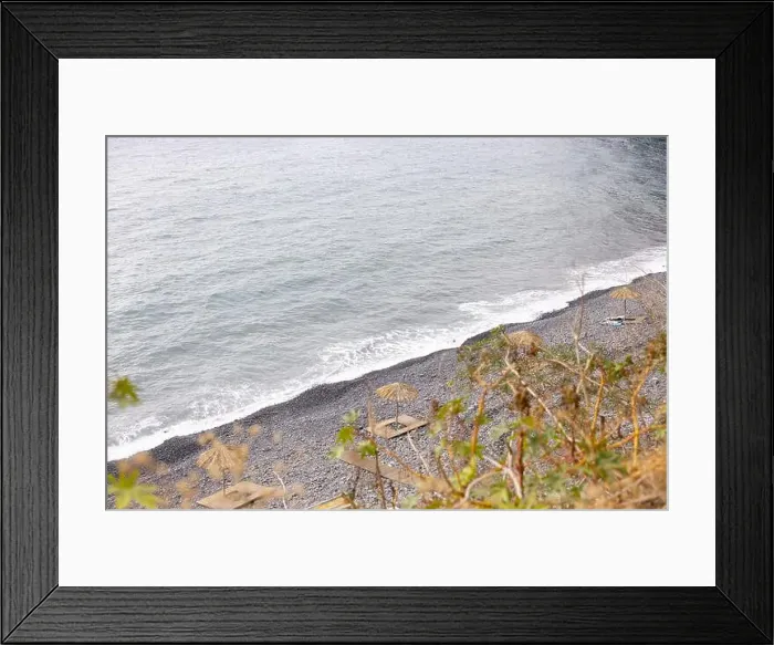 Framed Print : Praia dos Anjos, composed of basalt pebbles and black sand with straw umbrellas and wooden decks Framed Print : Praia dos Anjos, composed of basalt pebbles and black sand with straw umbrellas and wooden decks
