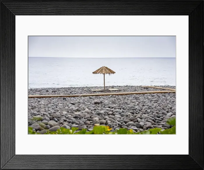 Framed Print : Praia dos Pescadores beach, composed of basalt pebbles and black sand with straw umbrellas and wooden decks Framed Print : Praia dos Pescadores beach, composed of basalt pebbles and black sand with straw umbrellas and wooden decks