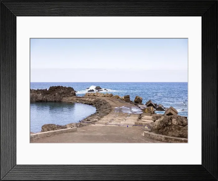 Framed Print : View of the natural pool and Atlantic Ocean separated by a pier in Seixal. Madeira Island, Portugal Framed Print : View of the natural pool and Atlantic Ocean separated by a pier in Seixal. Madeira Island, Portugal