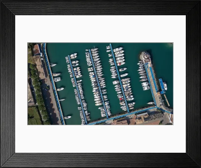 Framed Print : Aerial view of a marina with rows of boats docked in the calm turquoise water Framed Print : Aerial view of a marina with rows of boats docked in the calm turquoise water