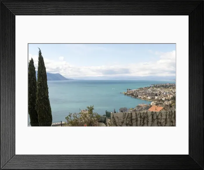 Framed Print : A scenic view of Lake Geneva, with mountains in the background and a charming town nestled along the shoreline Framed Print : A scenic view of Lake Geneva, with mountains in the background and a charming town nestled along the shoreline