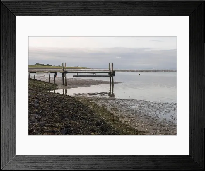 Framed Print : A wooden pier stretches over the tidal flats at low tide in the Wadden Sea Framed Print : A wooden pier stretches over the tidal flats at low tide in the Wadden Sea