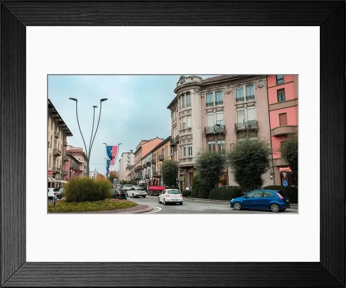 Framed Print : A lively street in Alba Italy shows elegant historic buildings nestled among modern vehicles Framed Print : A lively street in Alba Italy shows elegant historic buildings nestled among modern vehicles